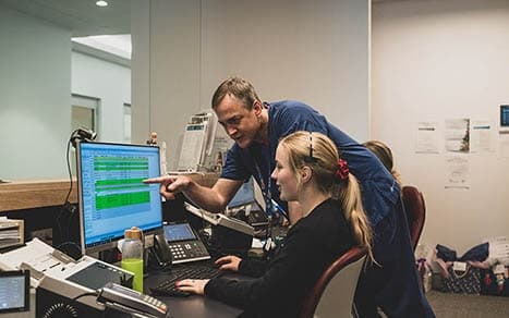 Specialist and practice manager adding patient into practice management software