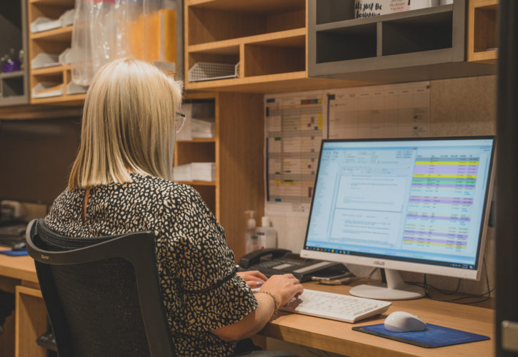 Practice manager using Genie Solutions on her computer to manage her medical practice.