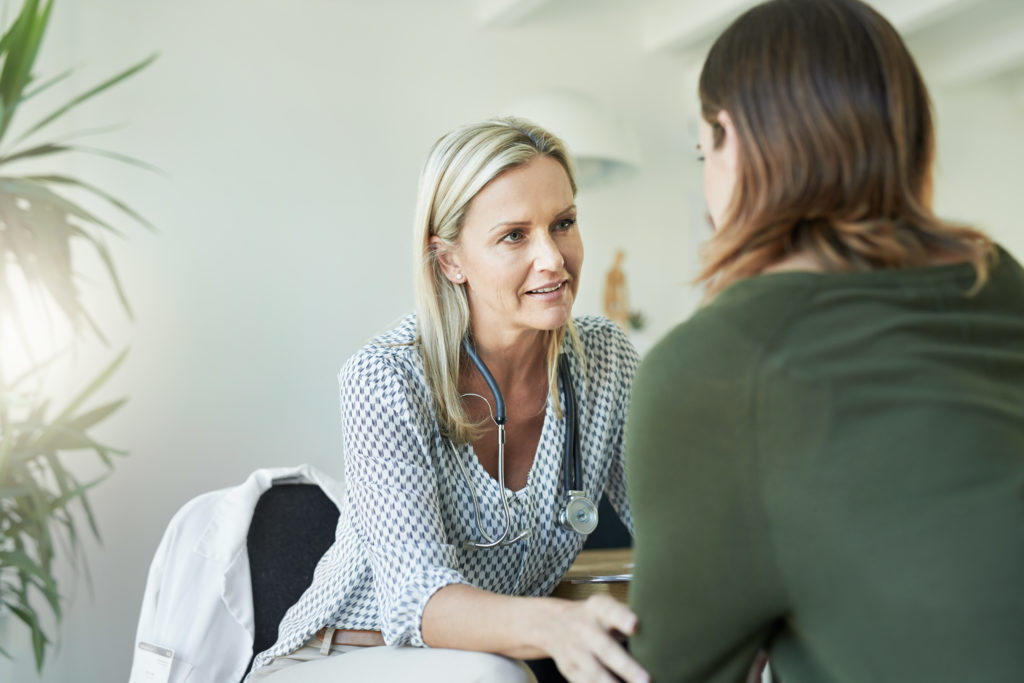 Specialist talking to patient in clinic