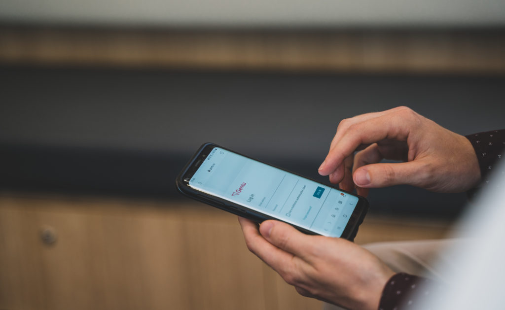 Specialist using Gentu software on mobile phone