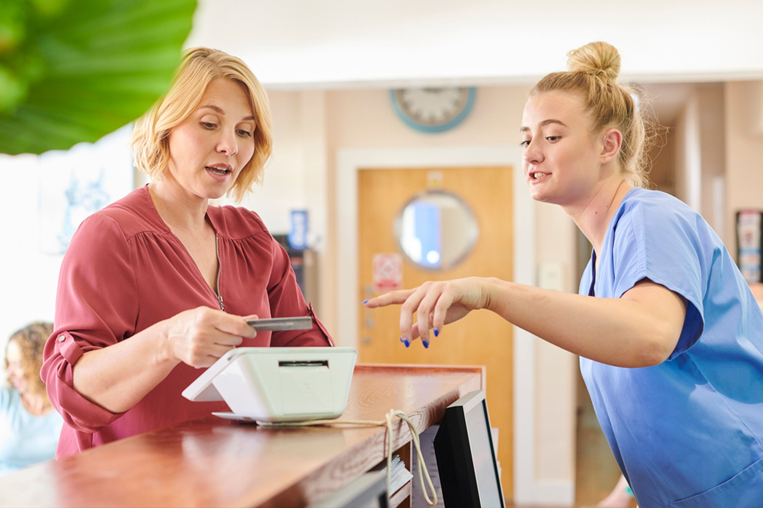 Patient at clinic paying for medical bill